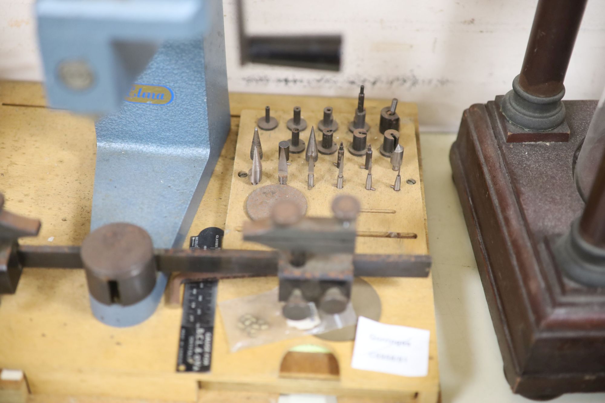 Watch & Clockmakers tools - an Elma bushing tool, the base with two integral trays of bushes, 36.5cm wide